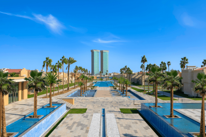 Expansive water promenade and palm-lined walkway at Rixos Obhur Jeddah