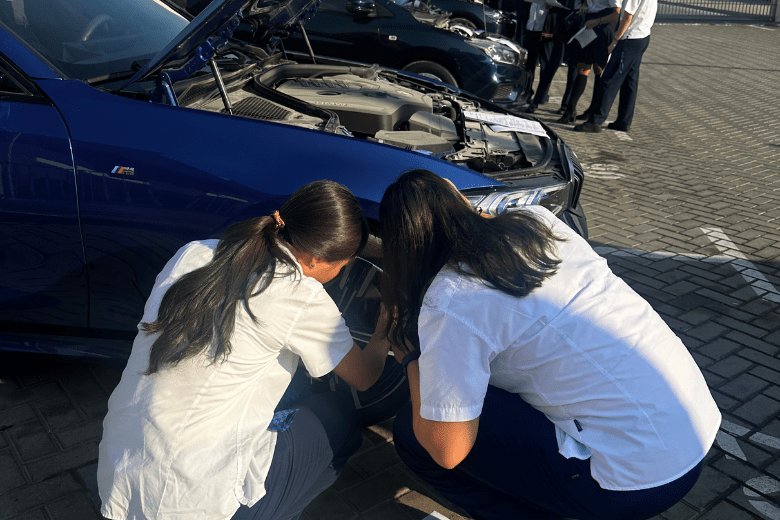 Students in the UAE practising tyre changing with guidance from The Mobile Mechanic during a hands-on life skills session