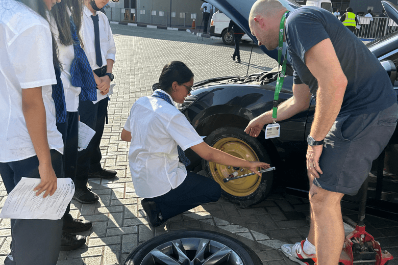The Mobile Mechanic demonstrating how to safely change a tyre during a school workshop