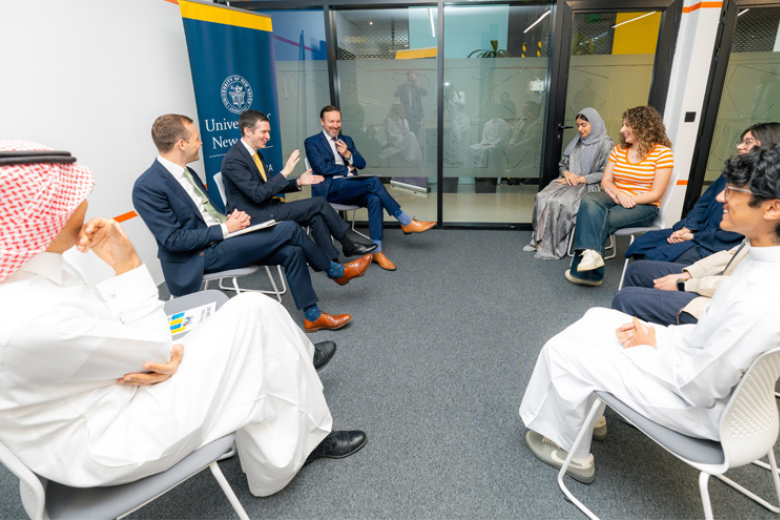 U.S. Senator Chris Murphy of Connecticut (seated farthest from the camera on the left) speaks with a small group at the University of New Haven – Riyadh, alongside Senior Vice President Leo Lester seated to his immediate right